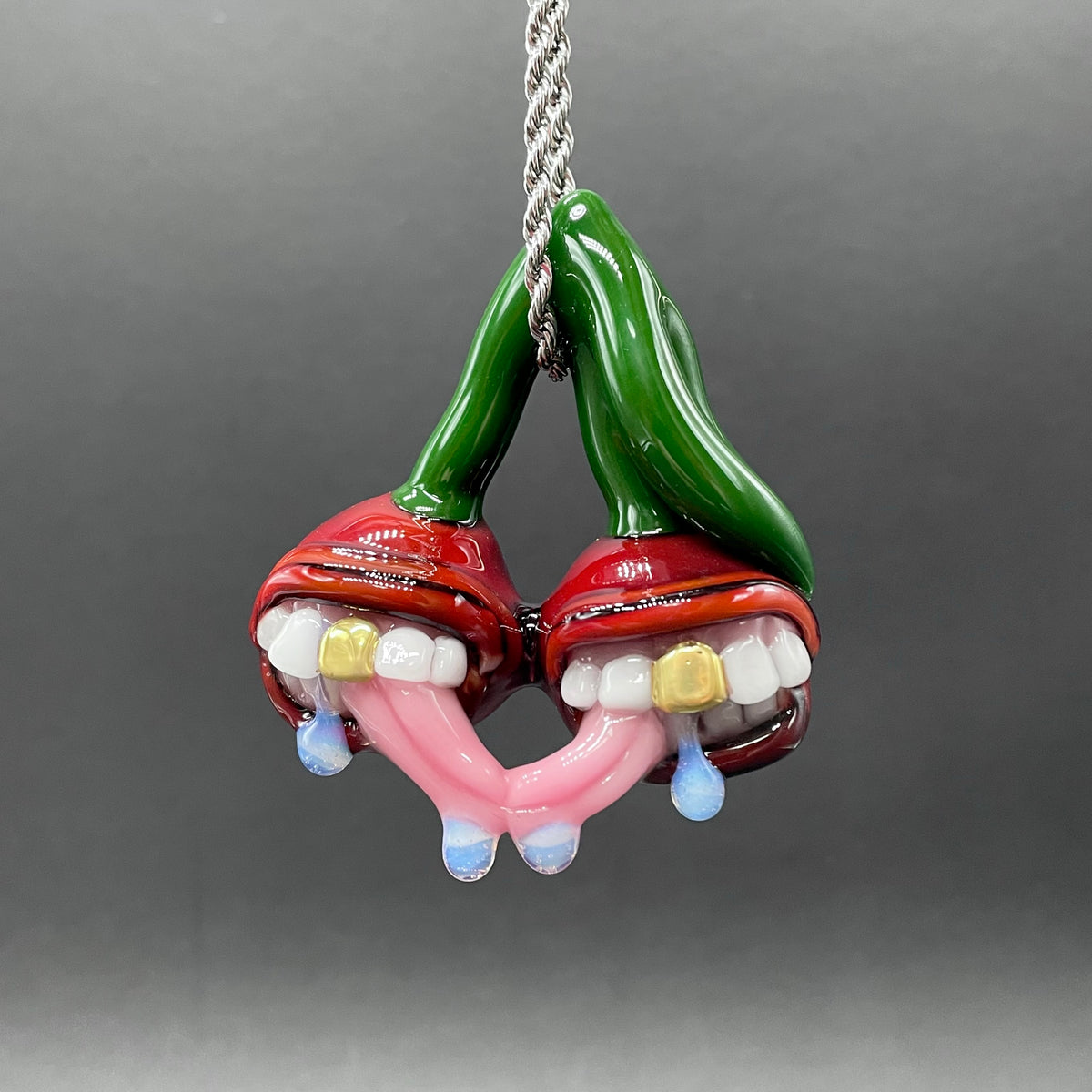 Cherry Lover handblown glass pendant - paired red cherries with green stem, each with open grinning mouth, white teeth, gold tooth, pink tongues, silver rope chain - Leviathan Glass
