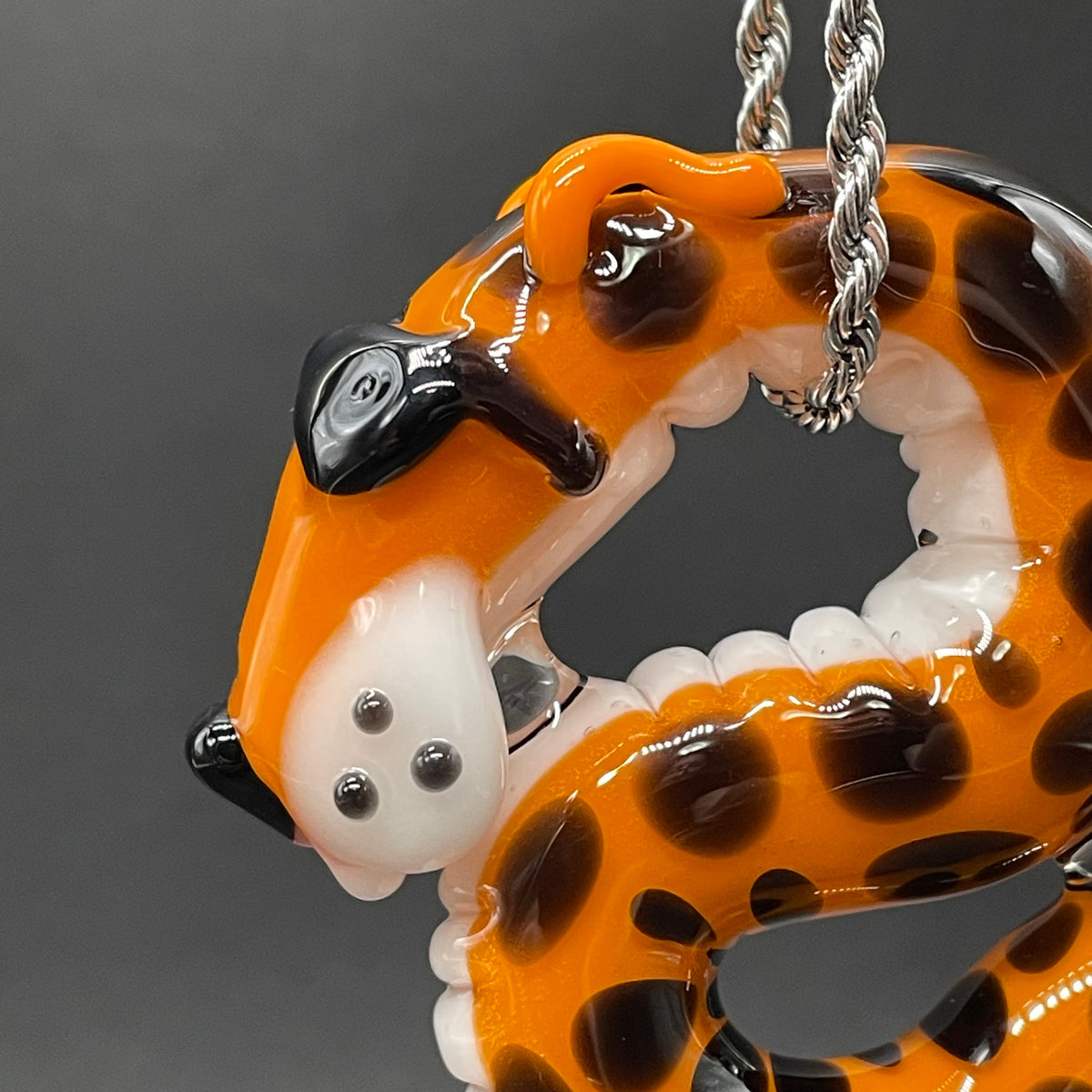 Close-up of Slithering Chester Cheetah glass pendant - handcrafted glass