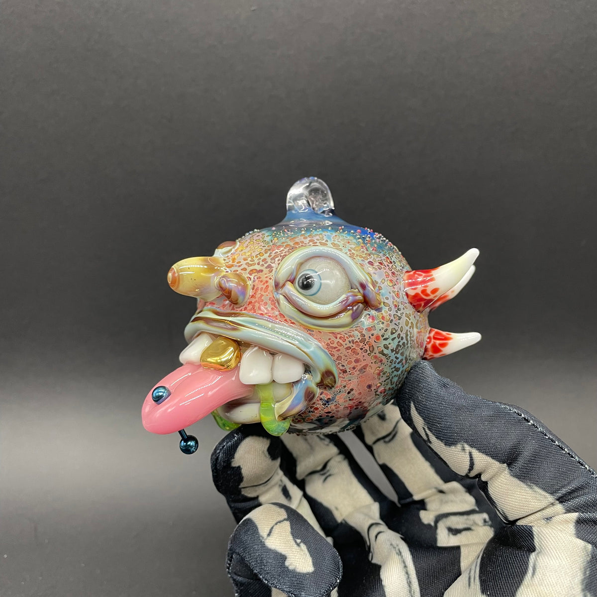 Hand-blown glass Pierced tongue cyclops ornament by Leviathan Glass