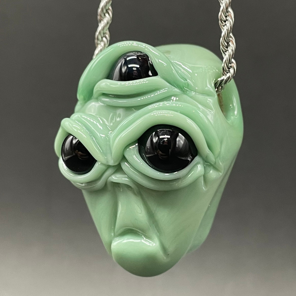 Time manipulating three eye glass alien pendant