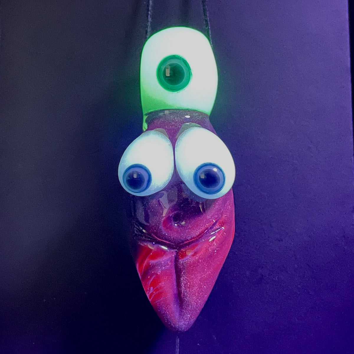 Black light reactive fertility pendant detail view - premium glass art