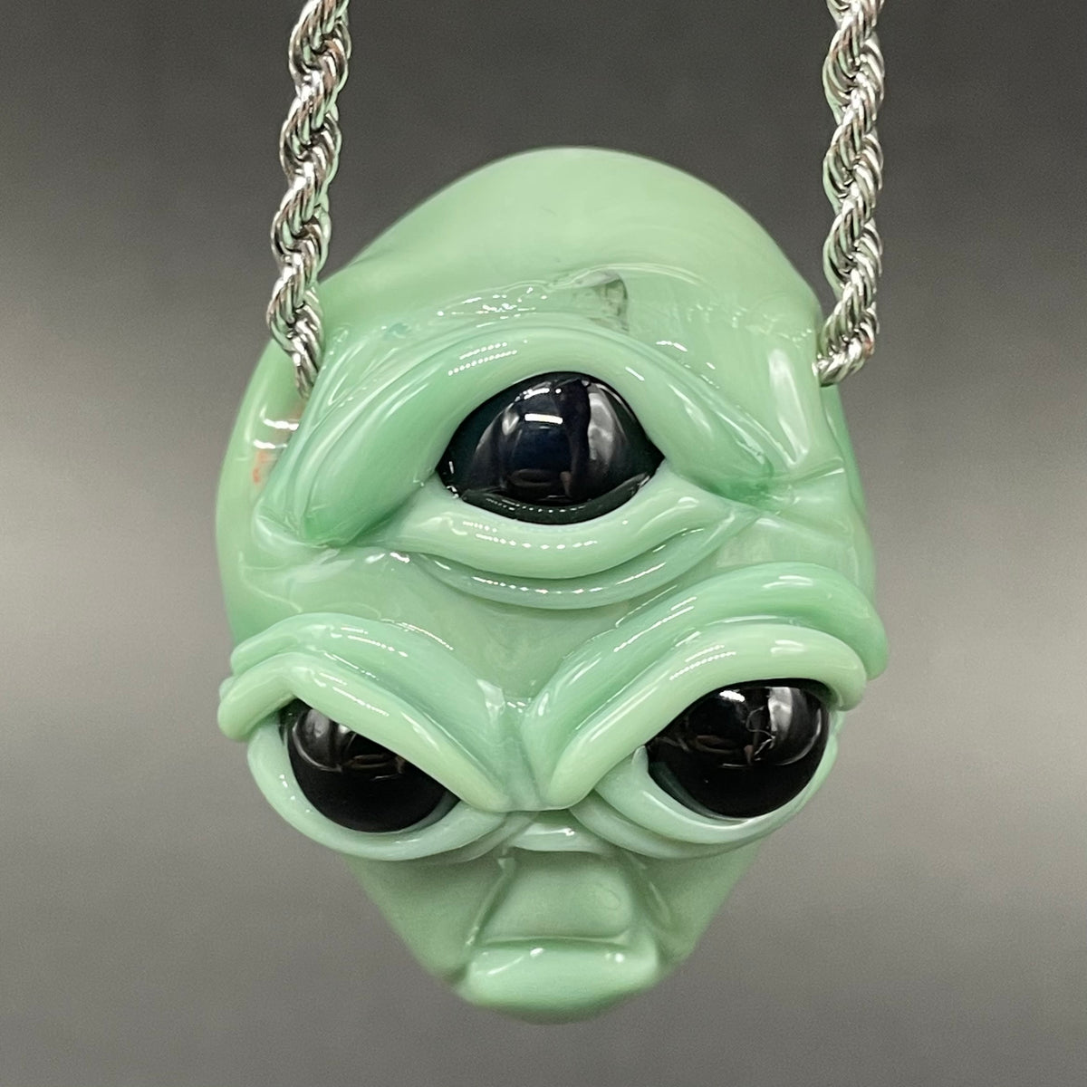 Time manipulating three eye glass alien pendant