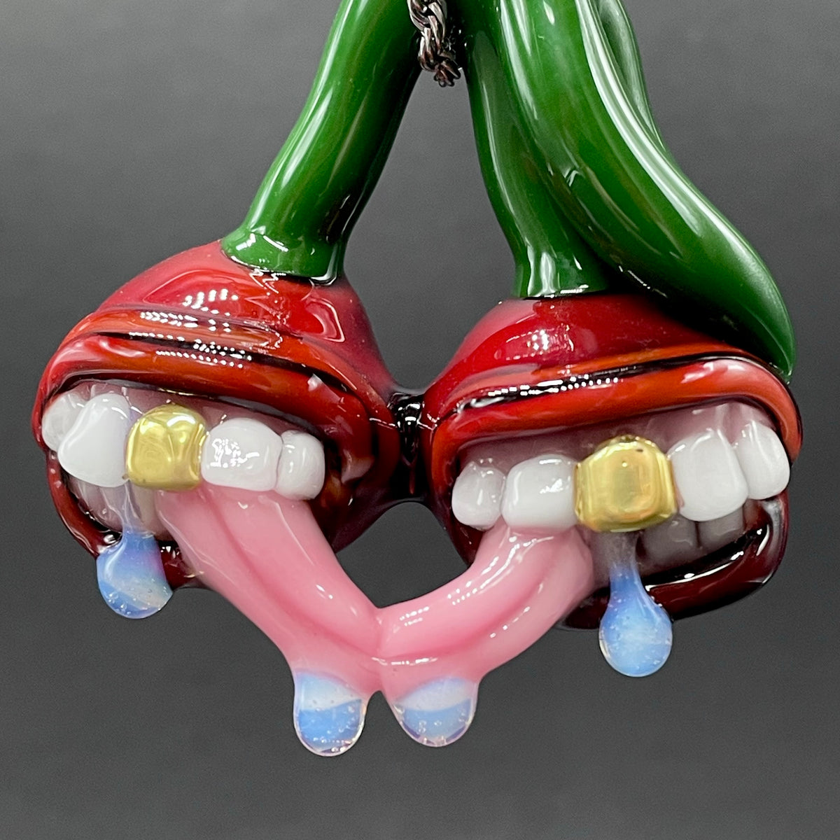 Cherry Lover handblown glass pendant - paired red cherries with green stem, each with open grinning mouth, white teeth, gold tooth, pink tongues, silver rope chain - Leviathan Glass