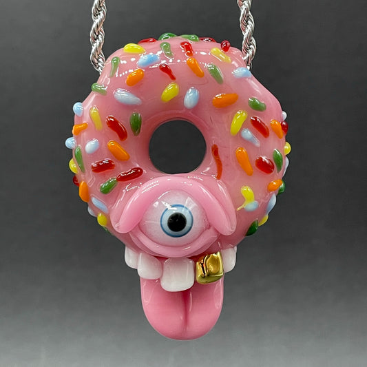 Mmmm Doughnuts handblown glass pendant - pink frosted donut with multicolor sprinkles, cyclops eye, white teeth, gold tooth, pink tongue, silver rope chain - Leviathan Glass
