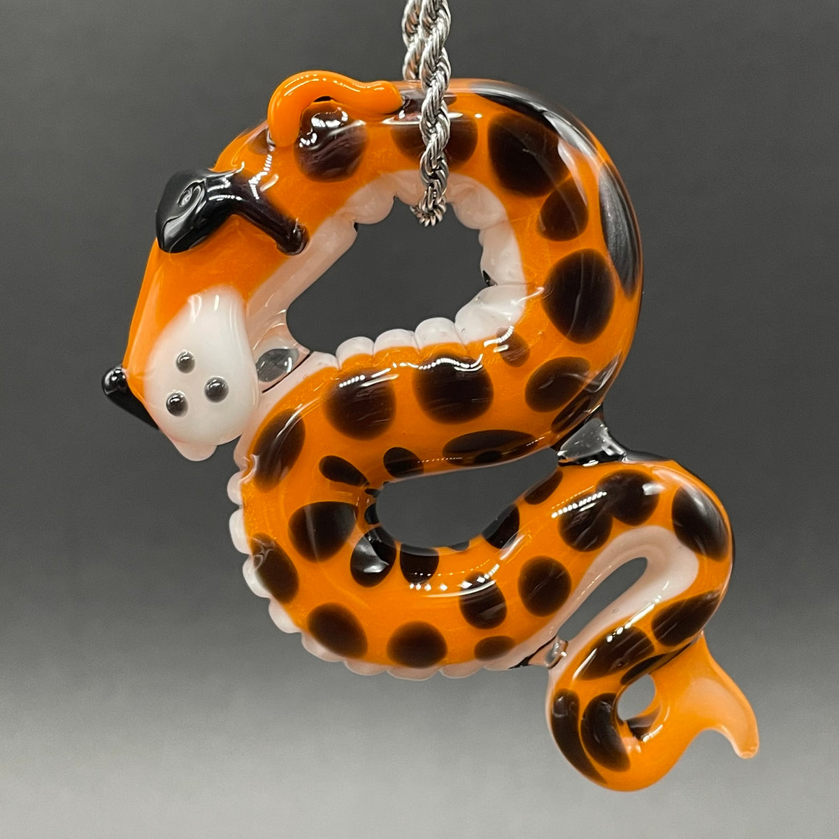Close-up of Slithering Chester Cheetah glass pendant - handcrafted glass