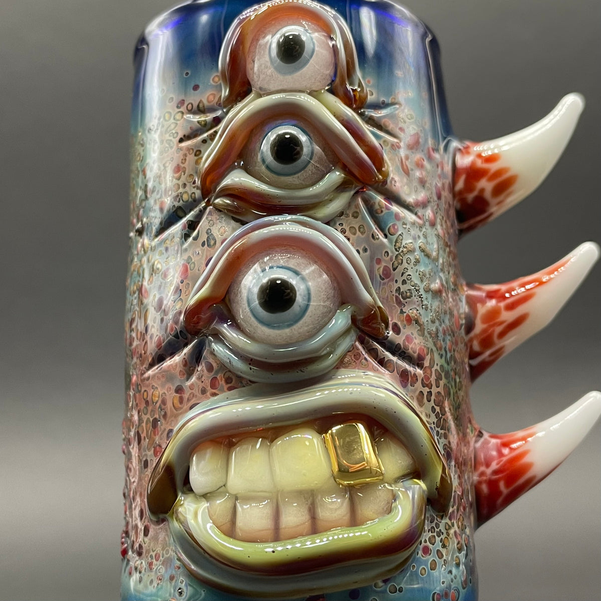 Close-up of Vertical 3 eye shot glass - handcrafted glass