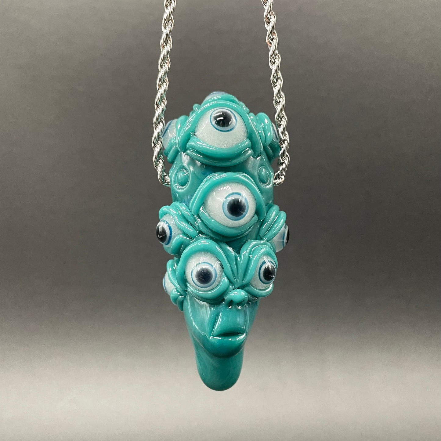 The Never-Blinking One glass effigy pendant detail view - premium glass art
