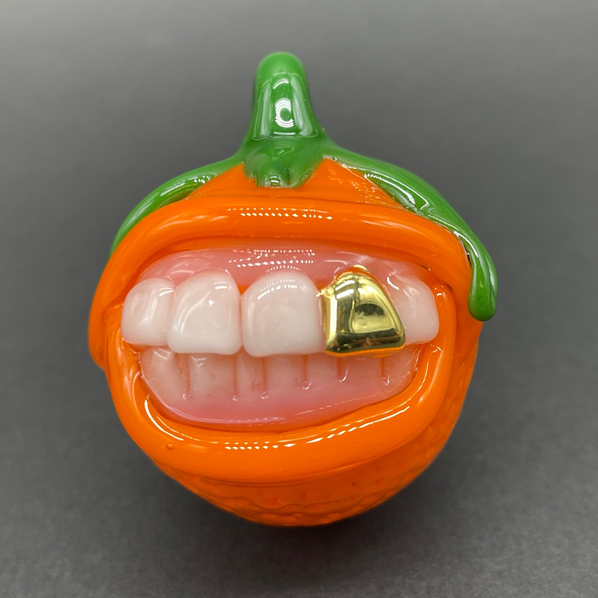 Close-up of Toothy orange pendant - handcrafted glass