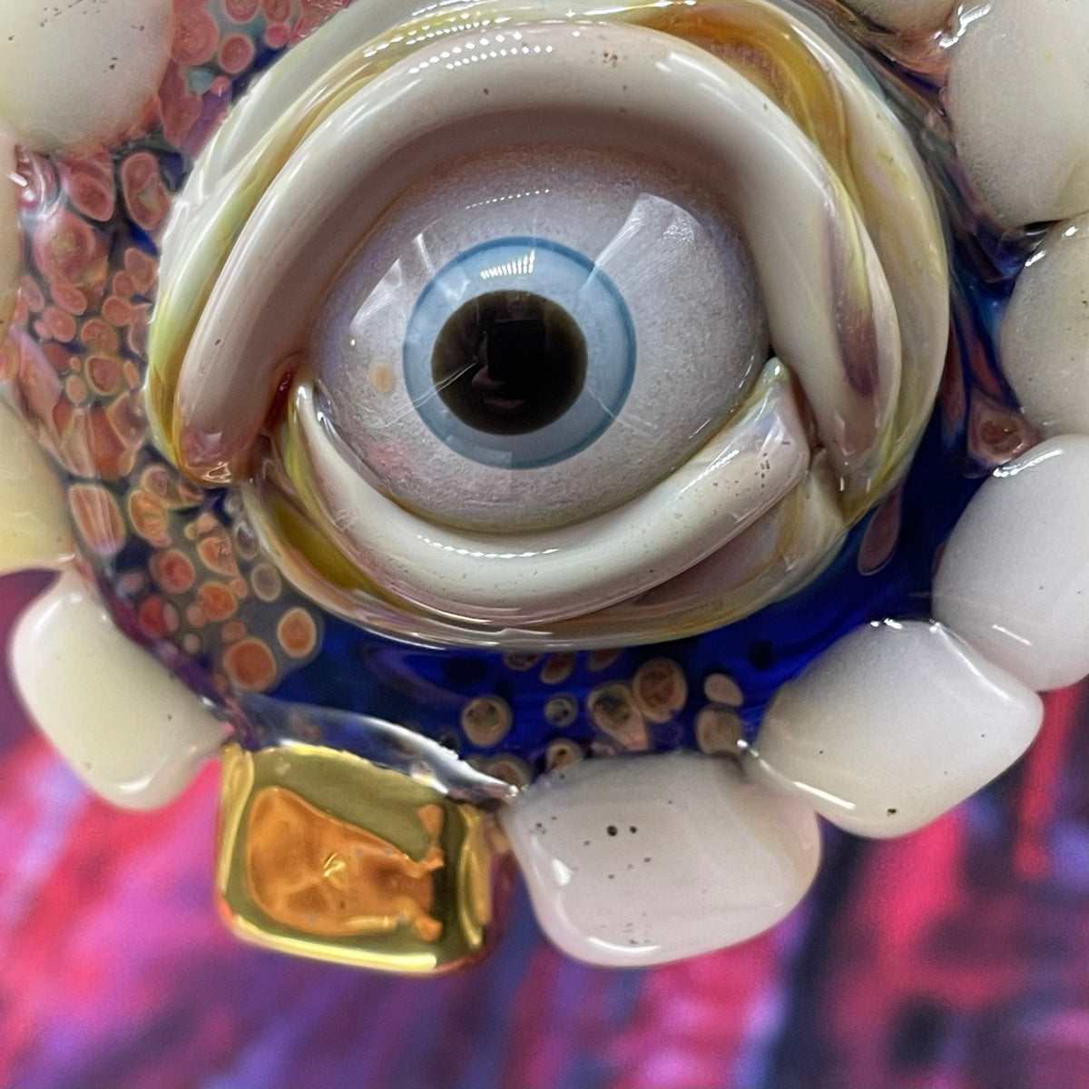 Unidentified Object Delta handblown glass pendant - circular disc ringed with ivory teeth, blue iris eye center, eyelid, gold tooth accent, silver rope chain - Leviathan Glass
