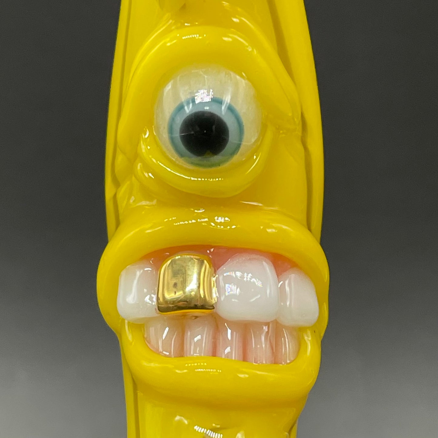 Grinning glass banana pendant