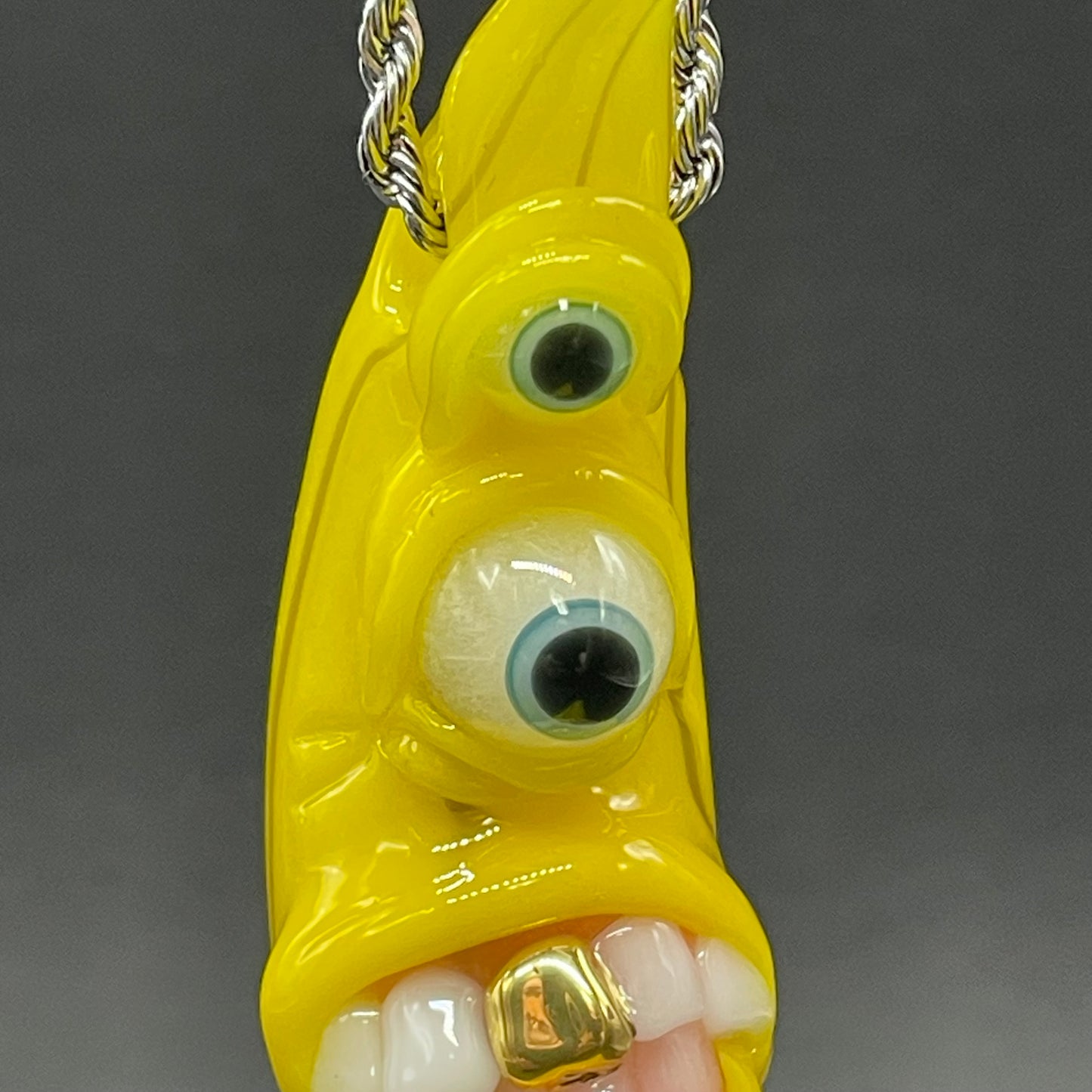 Grinning glass banana pendant