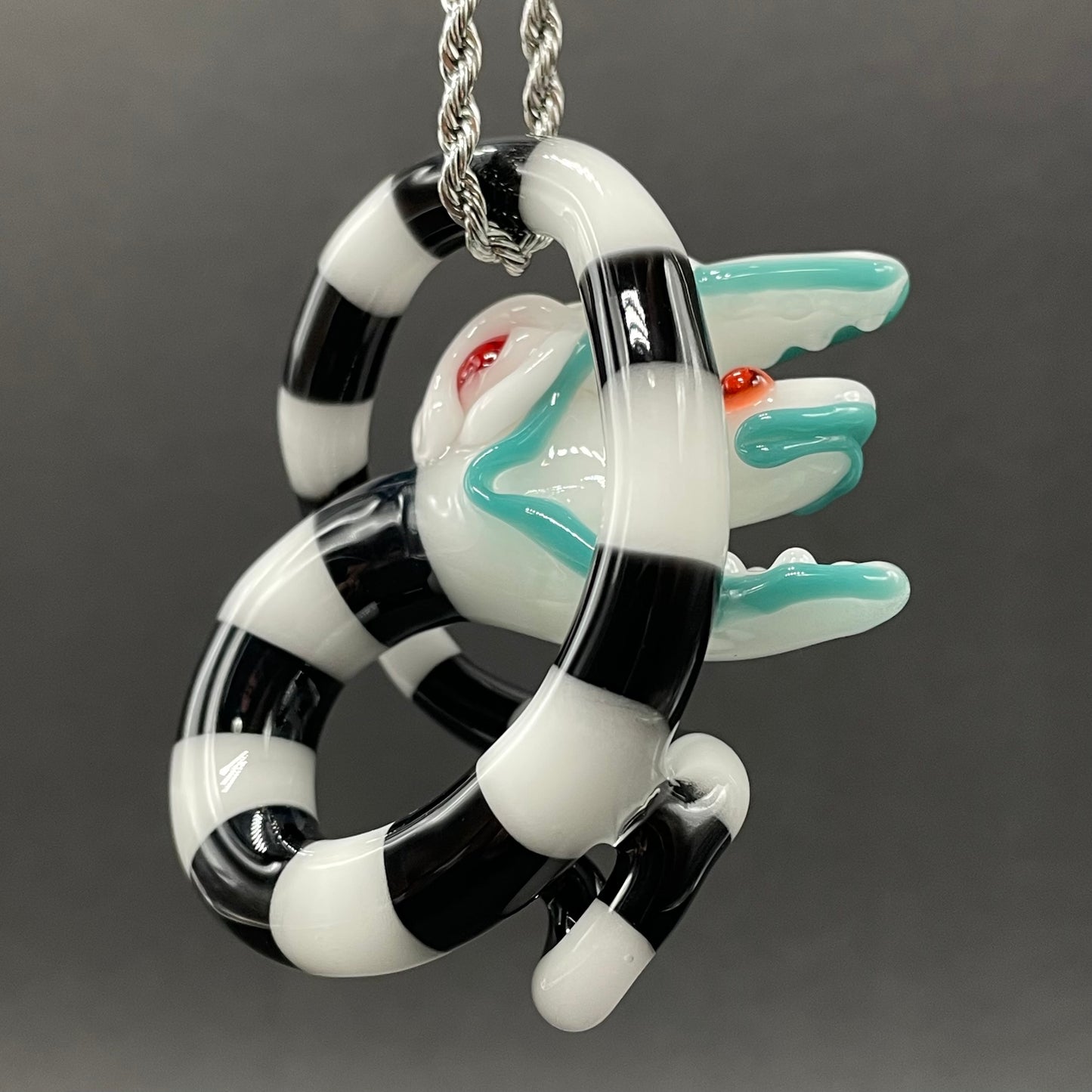 Beetlejuice Inspired handblown solid glass Sandworm sculpture - coiled black and white striped sandworm with white worm head, teal tongue, red eyes - Leviathan Glass