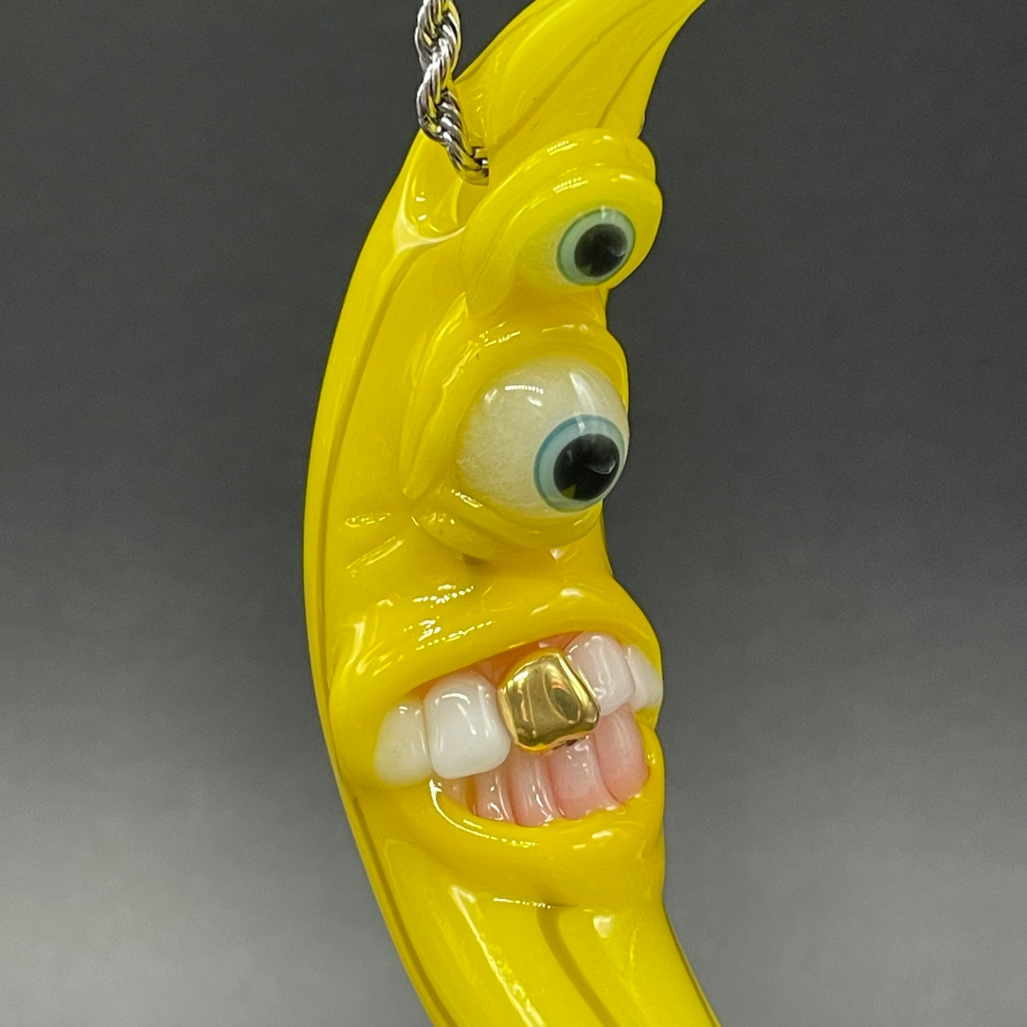 Grinning glass banana pendant