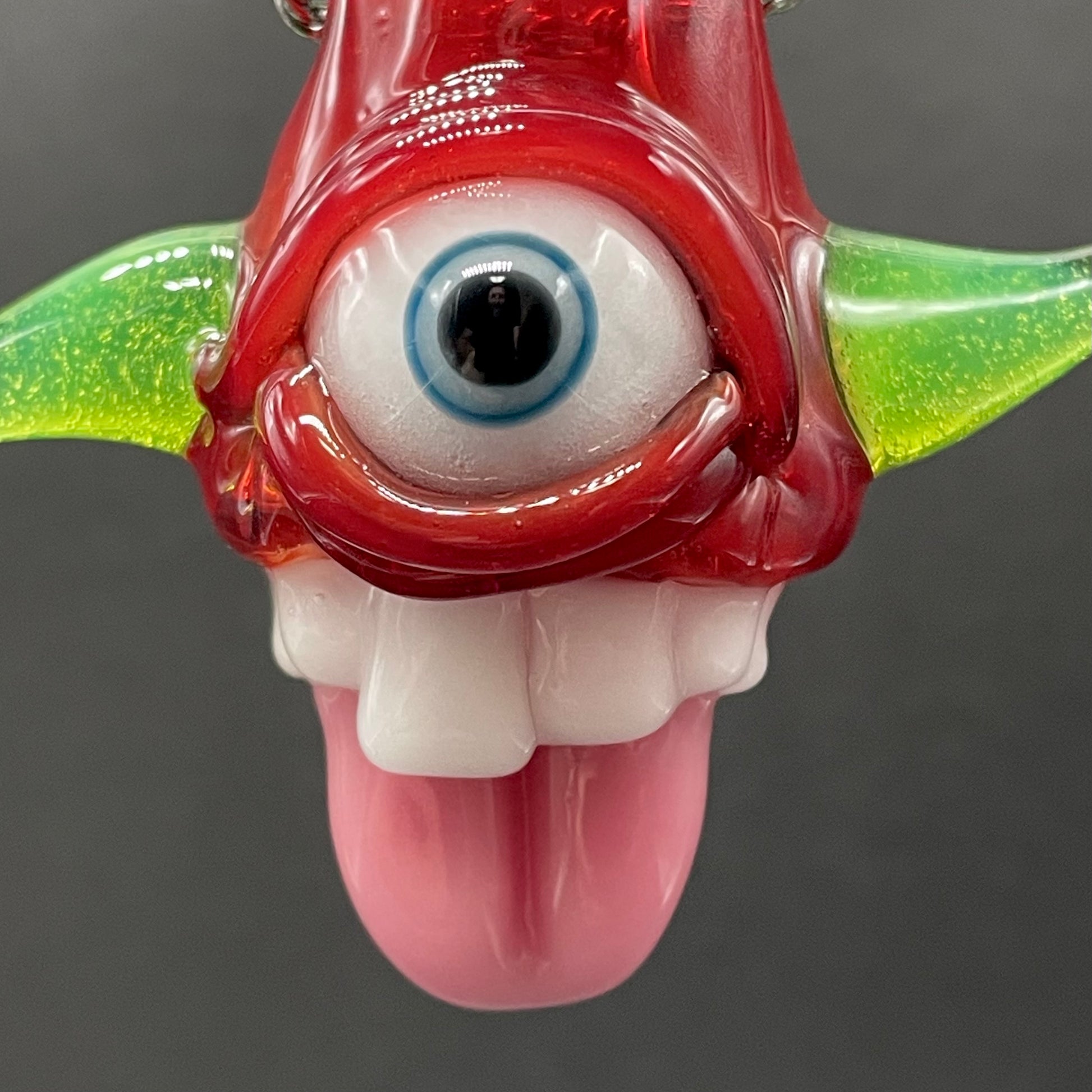 Close-up of Licky McOneEye glass pendant - handcrafted glass