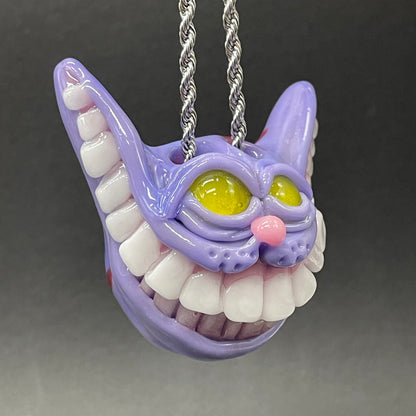 Grinning Cheshire cat glass pendant