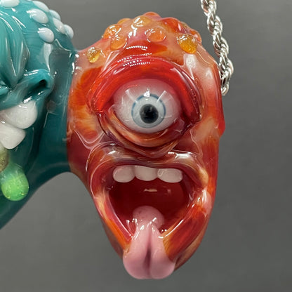 Two Headaches Are Better Than One handblown glass pendant - teal cyclops head with white teeth and green slime fused with red cyclops head with pink tongue, silver rope chain - Leviathan Glass