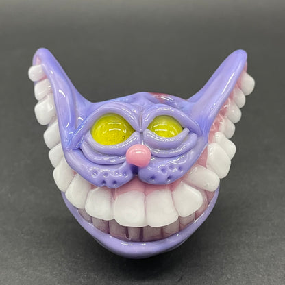 Grinning Cheshire cat glass pendant
