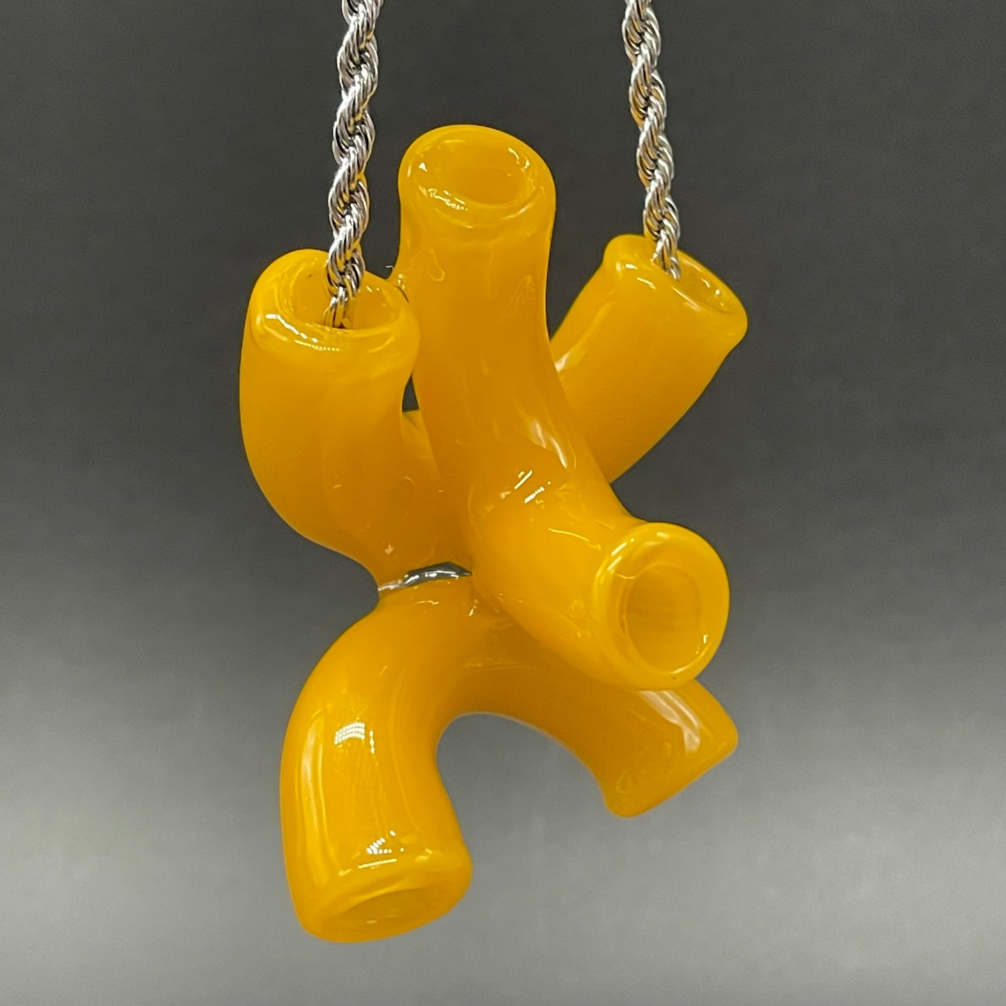 Close-up of Macaroni and cheese necklace - handcrafted glass
