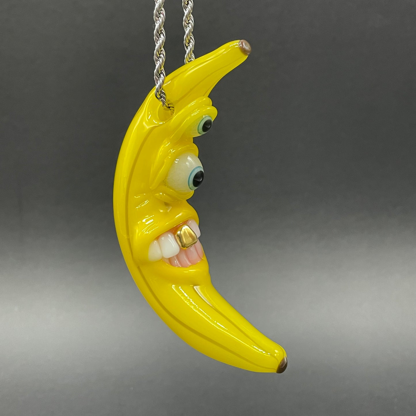 Grinning glass banana pendant