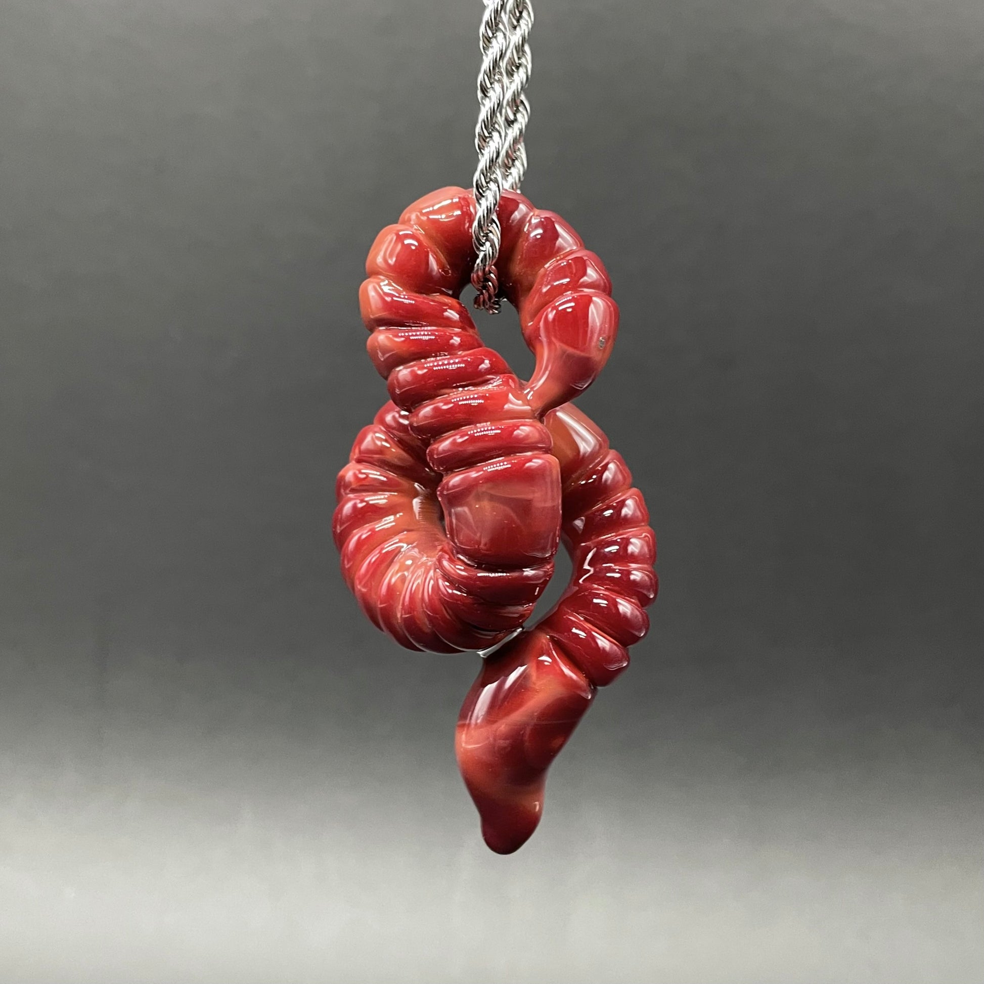 Hand-blown glass glass earthworm pendant by Leviathan Glass