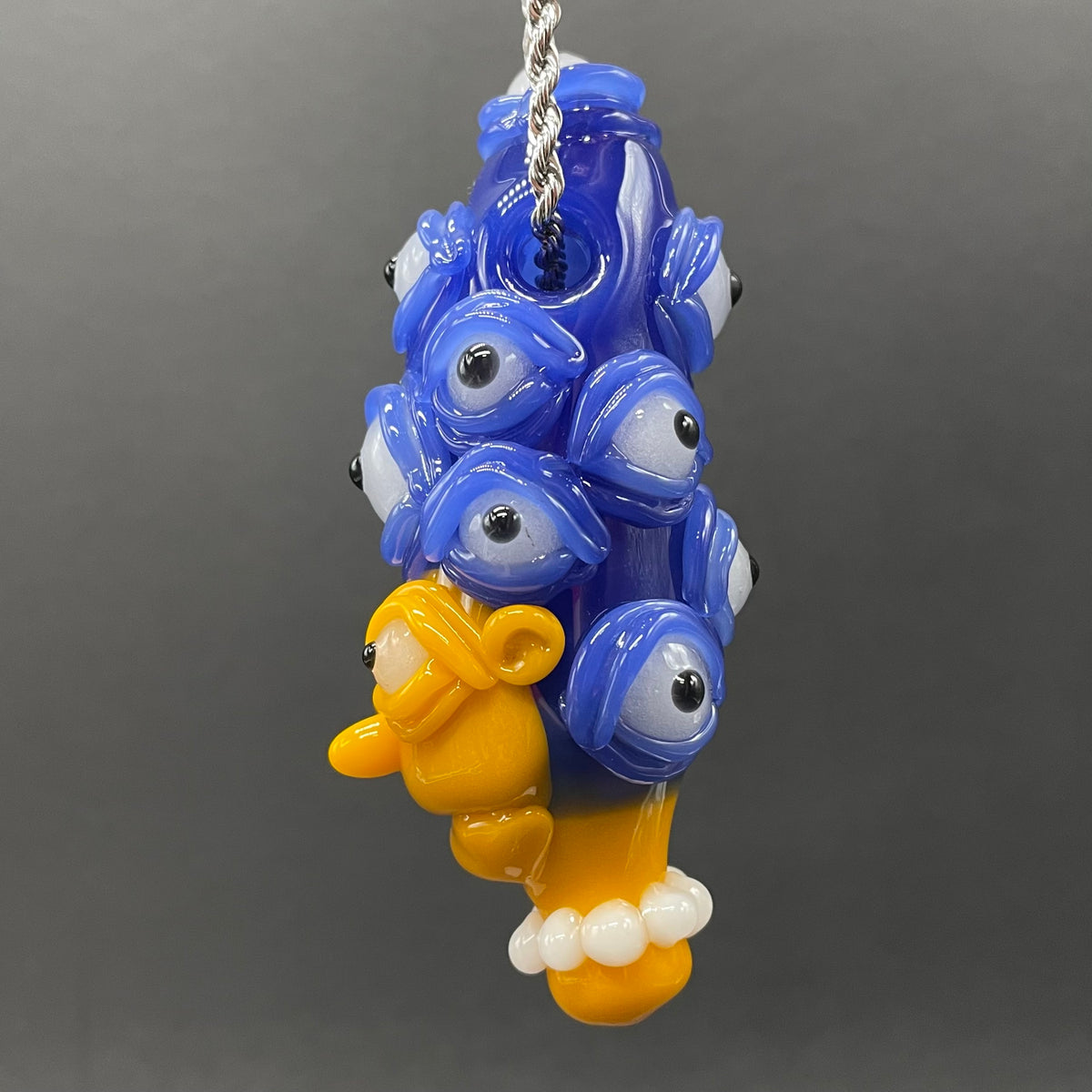 Marge Simpson Mutant handblown glass pendant - yellow Marge Simpson face with towering stack of blue cyclops creatures forming her hair, white pearl beads, silver rope chain - Leviathan Glass