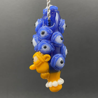 Marge Simpson Mutant handblown glass pendant - yellow Marge Simpson face with towering stack of blue cyclops creatures forming her hair, white pearl beads, silver rope chain - Leviathan Glass