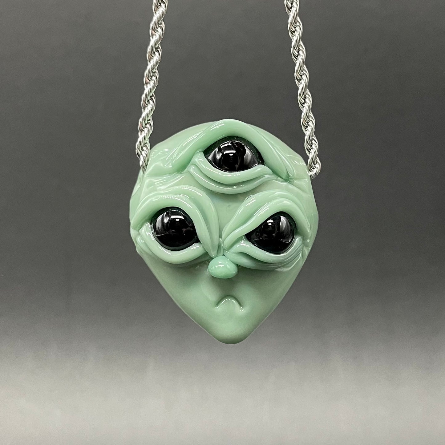 Time manipulating three eye glass alien pendant