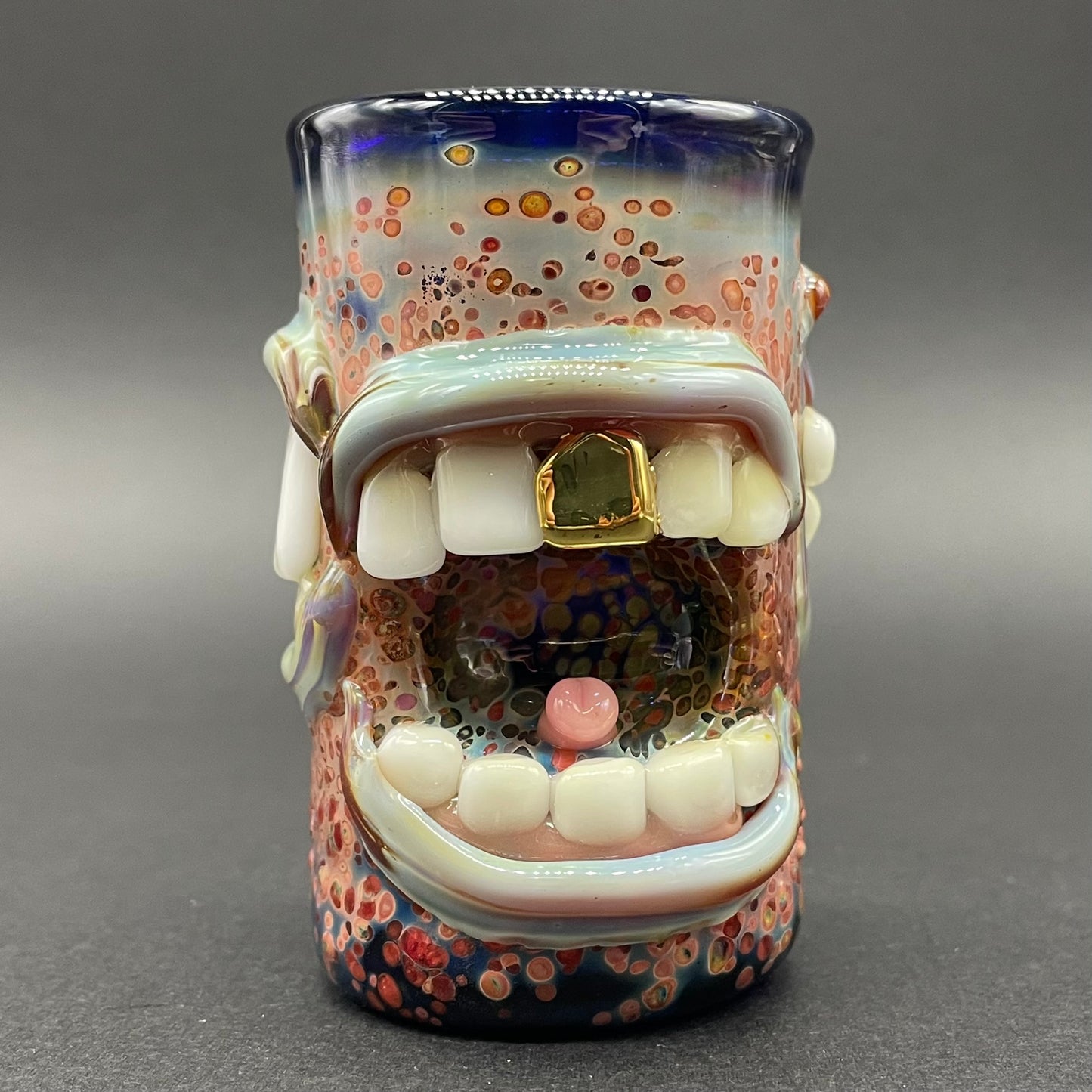 Close-up of Too many mouths to feed shot glass - handcrafted glass