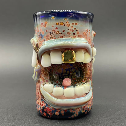 Close-up of Too many mouths to feed shot glass - handcrafted glass