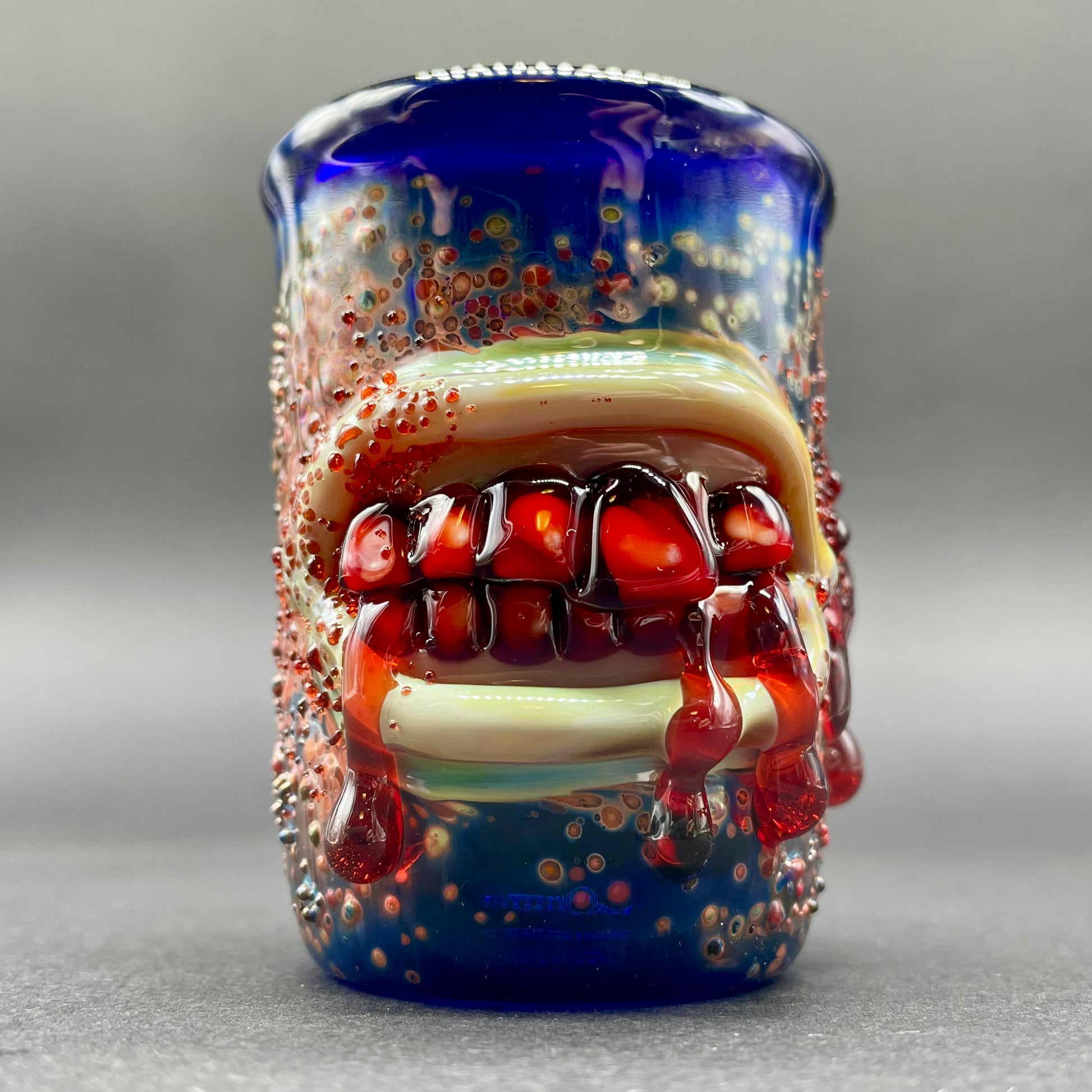 Close-up of Bite your tongue shot glass - handcrafted glass