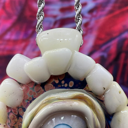Unidentified Object Delta handblown glass pendant - circular disc ringed with ivory teeth, blue iris eye center, eyelid, gold tooth accent, silver rope chain - Leviathan Glass