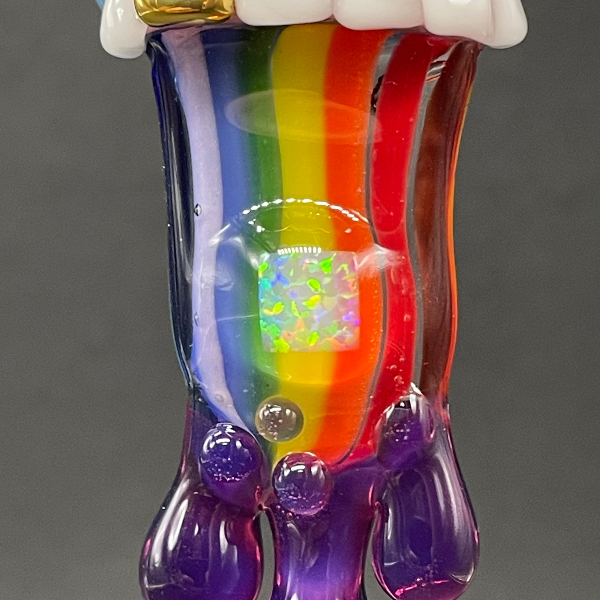 Close-up of Glass opal rainbow tongue pendant - handcrafted glass
