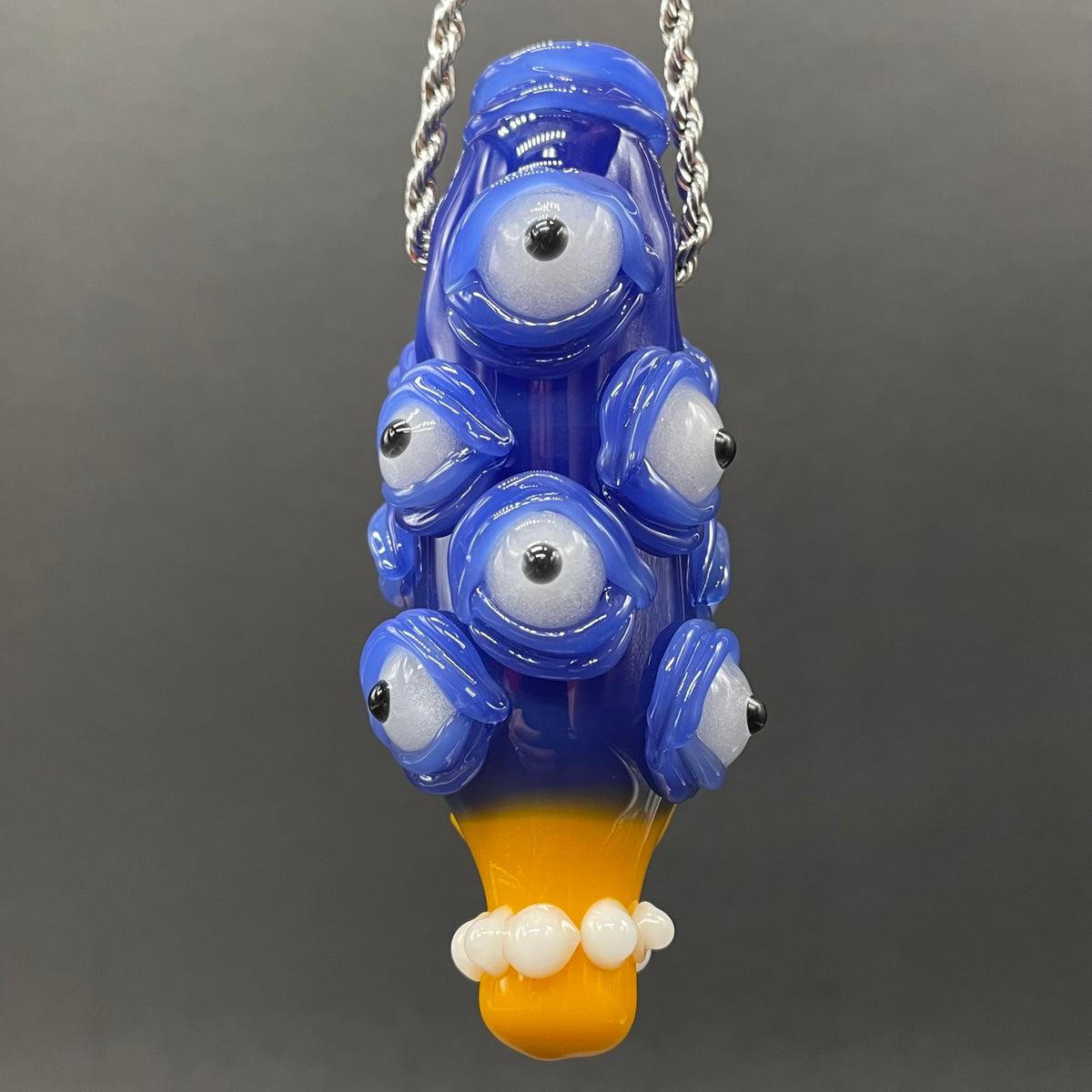 Marge Simpson Mutant handblown glass pendant - yellow Marge Simpson face with towering stack of blue cyclops creatures forming her hair, white pearl beads, silver rope chain - Leviathan Glass