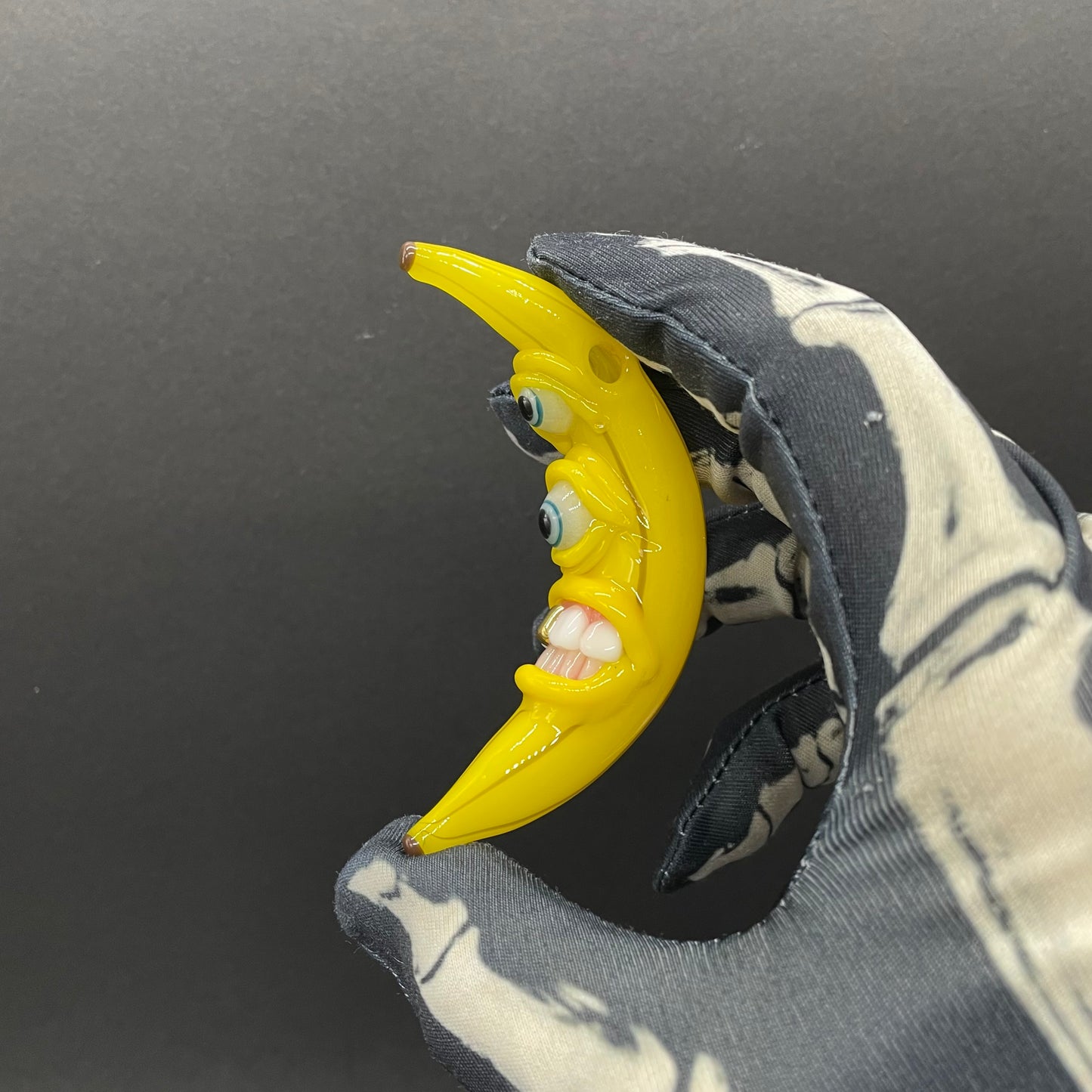 Grinning glass banana pendant