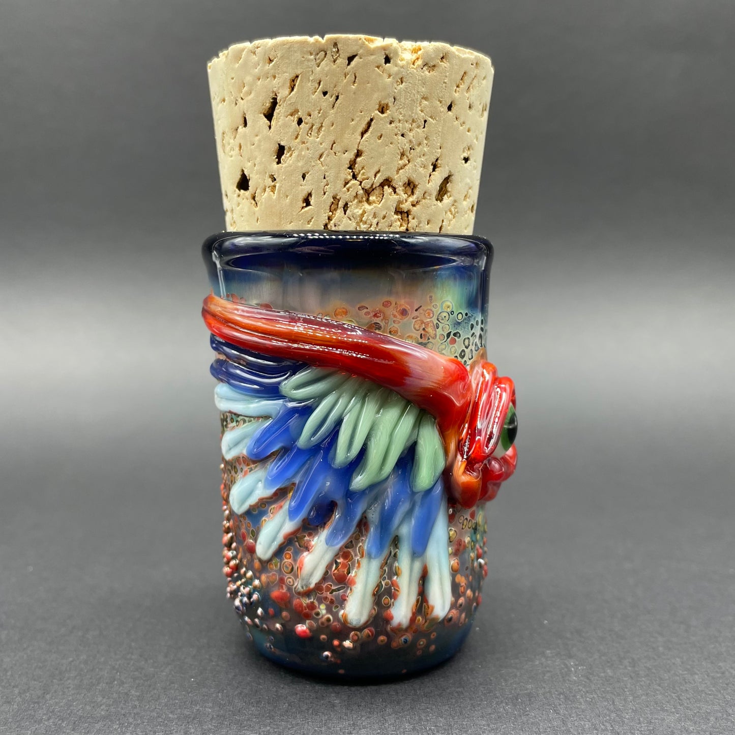 Close-up of Winged phoenix cork jar - handcrafted glass