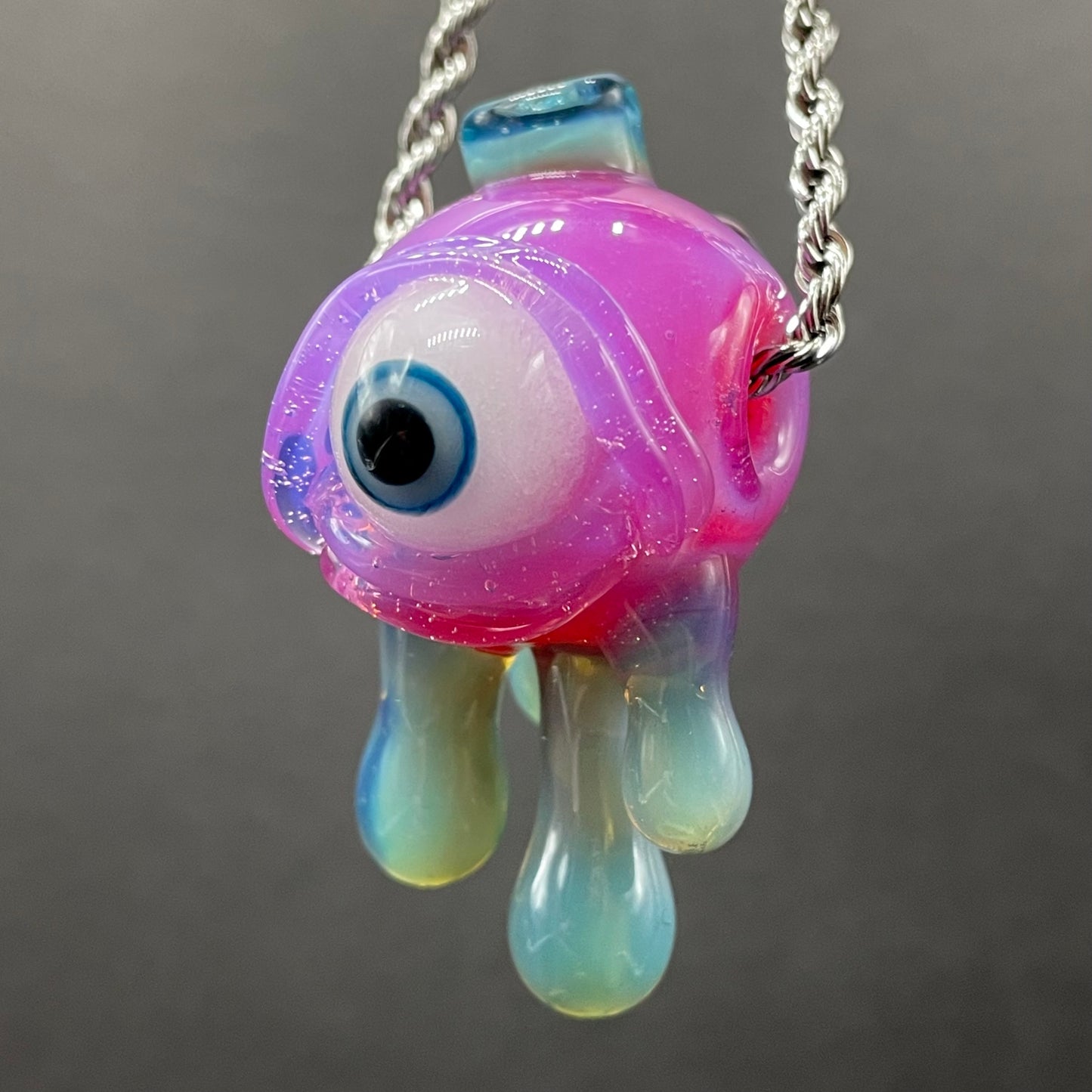 Close-up of Drippy cyclops glass pendant - handcrafted glass