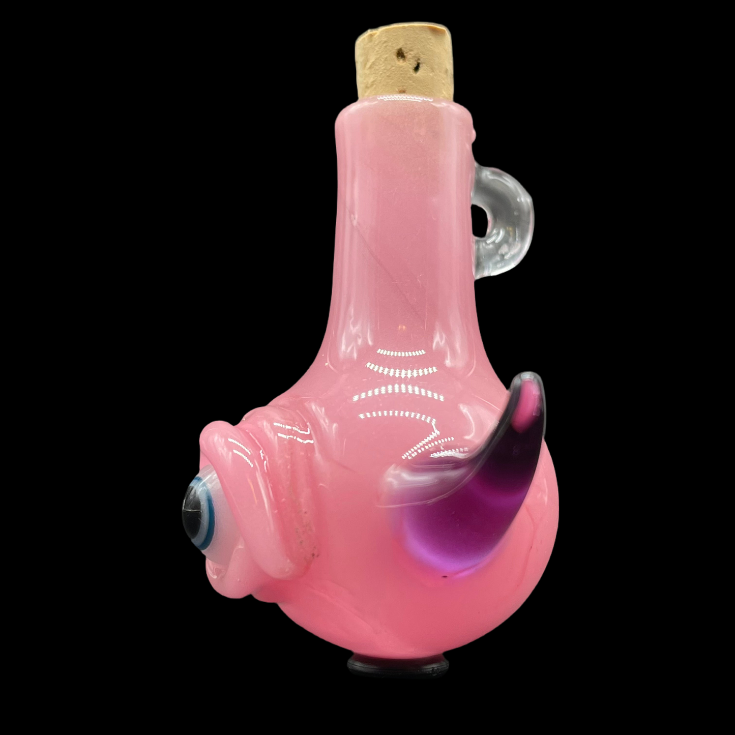 Close-up of Pink cyclops potion bottle - handcrafted glass