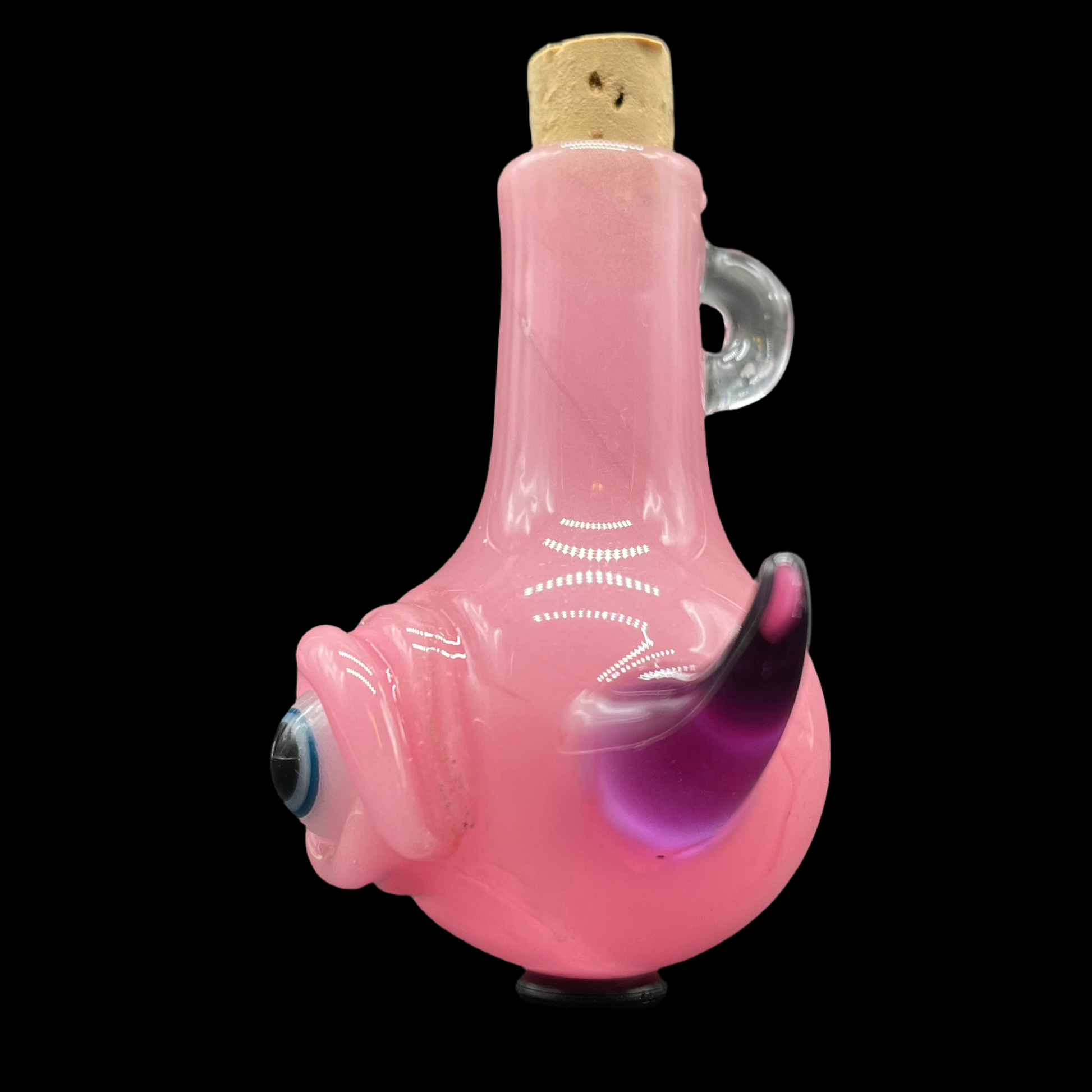 Close-up of Pink cyclops potion bottle - handcrafted glass