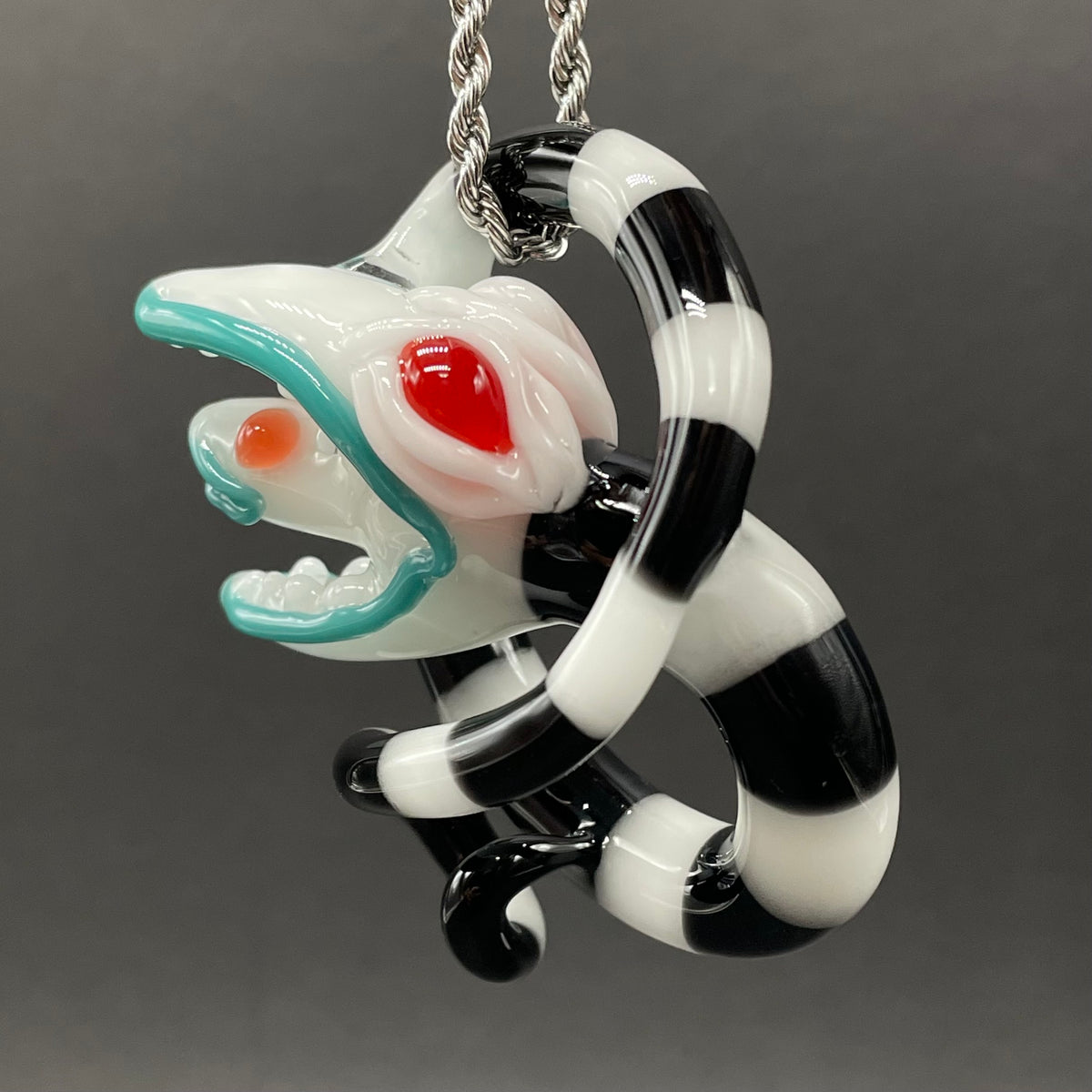 Beetlejuice Inspired handblown solid glass Sandworm sculpture - coiled black and white striped sandworm with white worm head, teal tongue, red eyes - Leviathan Glass