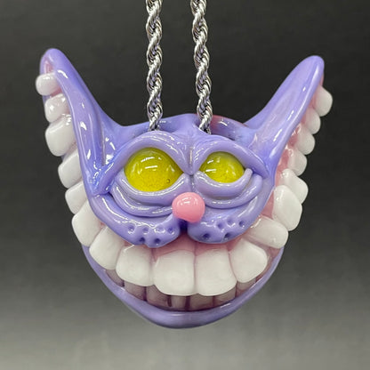 Grinning Cheshire cat glass pendant