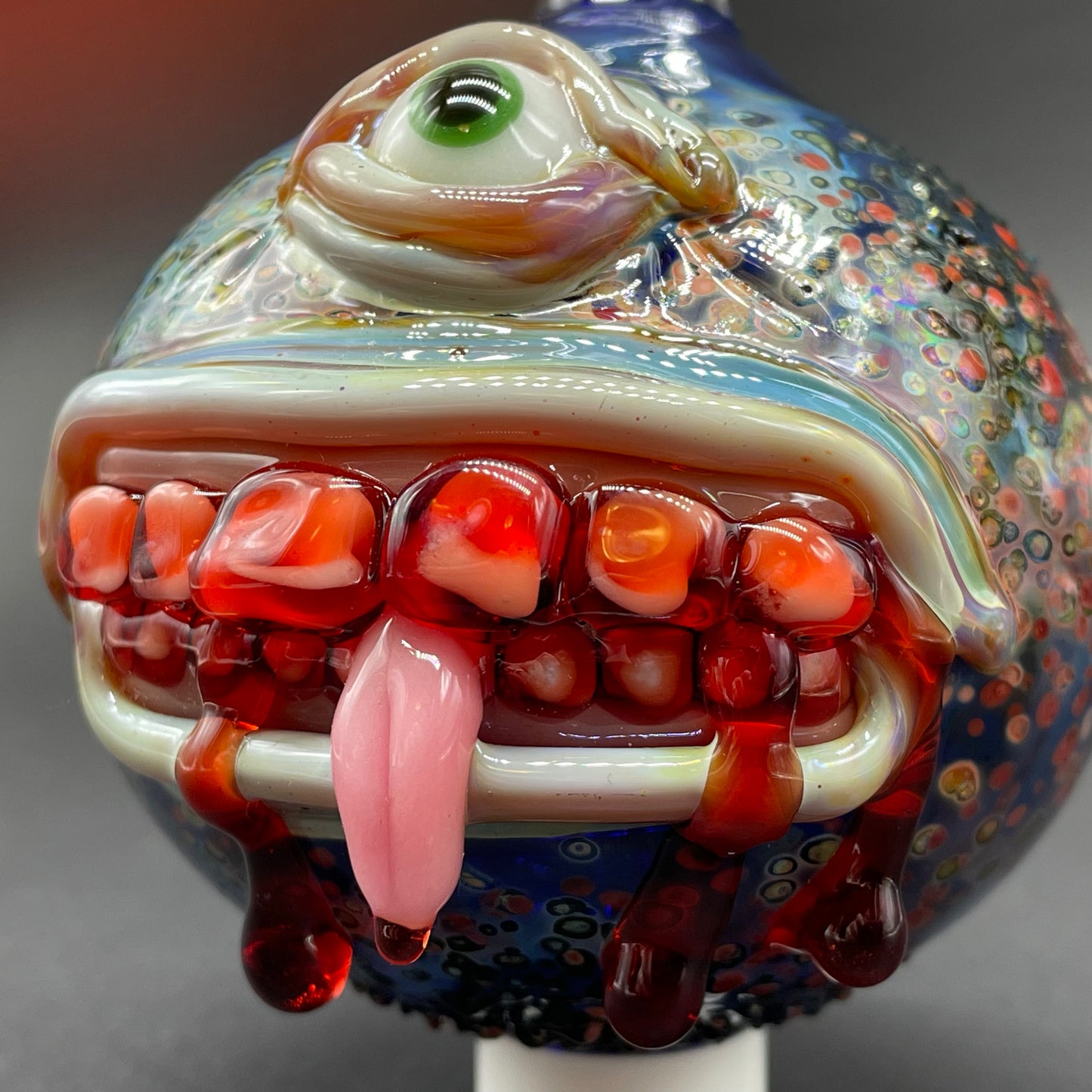 Close-up of Beware I Bite Ornament - handcrafted glass