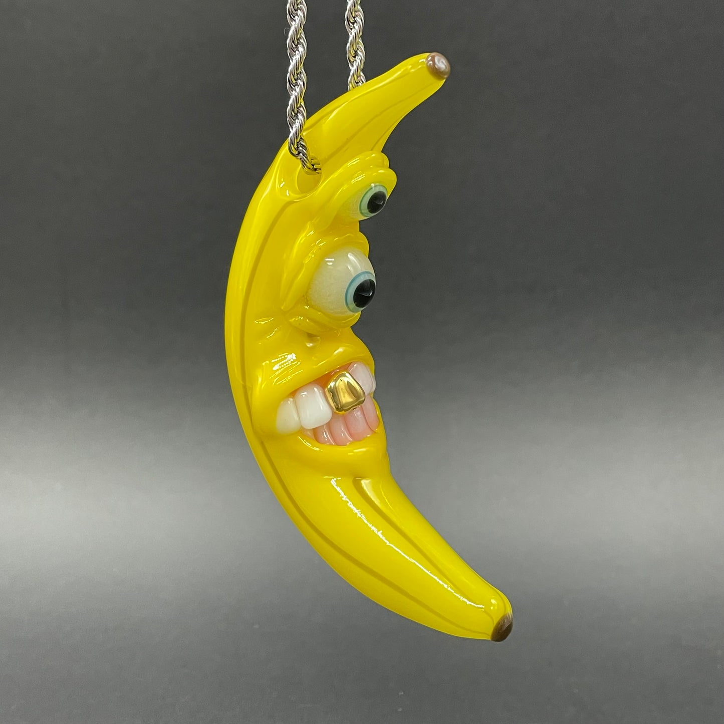Grinning glass banana pendant