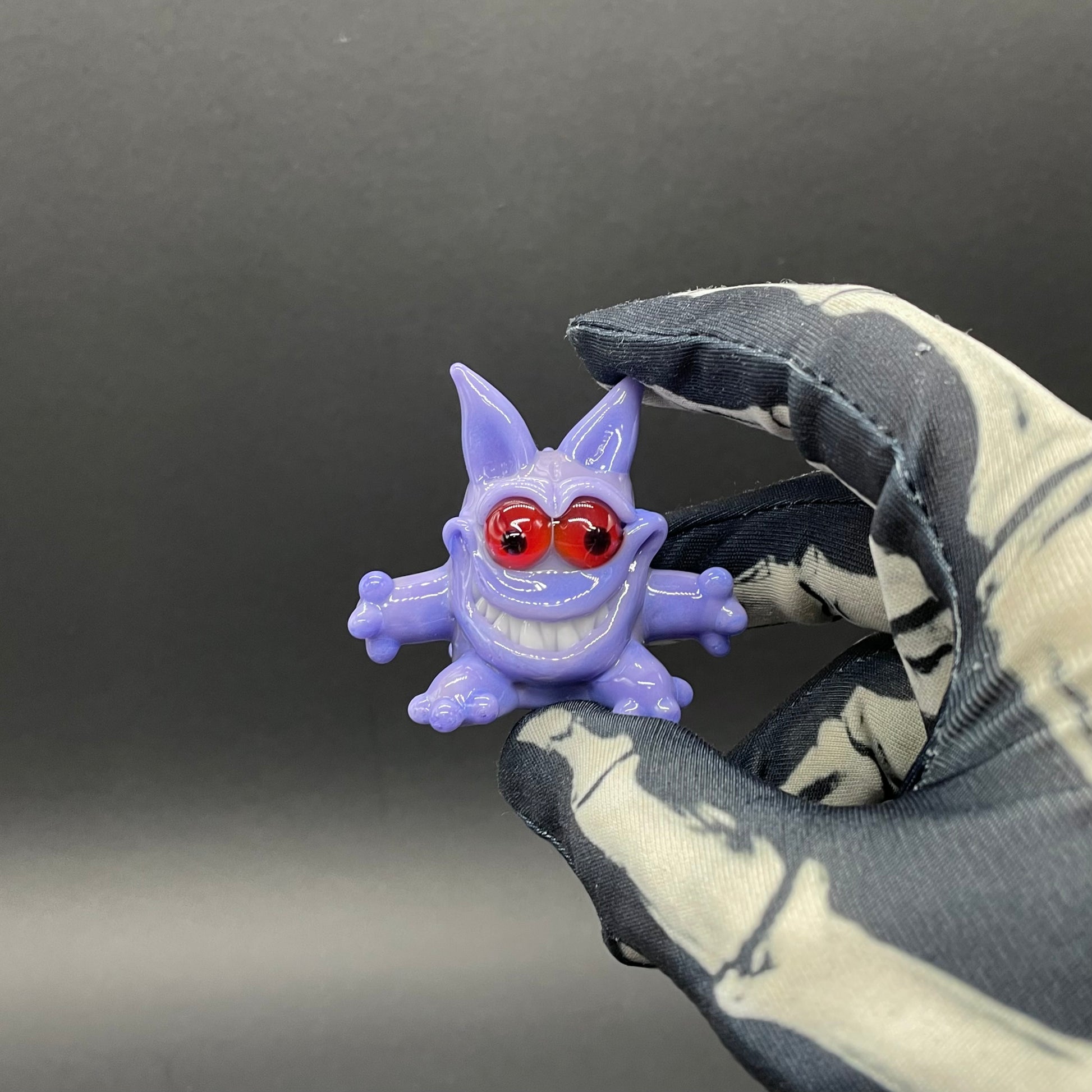 Gengar Pokémon handblown glass pendant - periwinkle purple Gengar sculpture, large red glass eyes, white teeth, clawed hands and feet, silver rope chain - Leviathan Glass