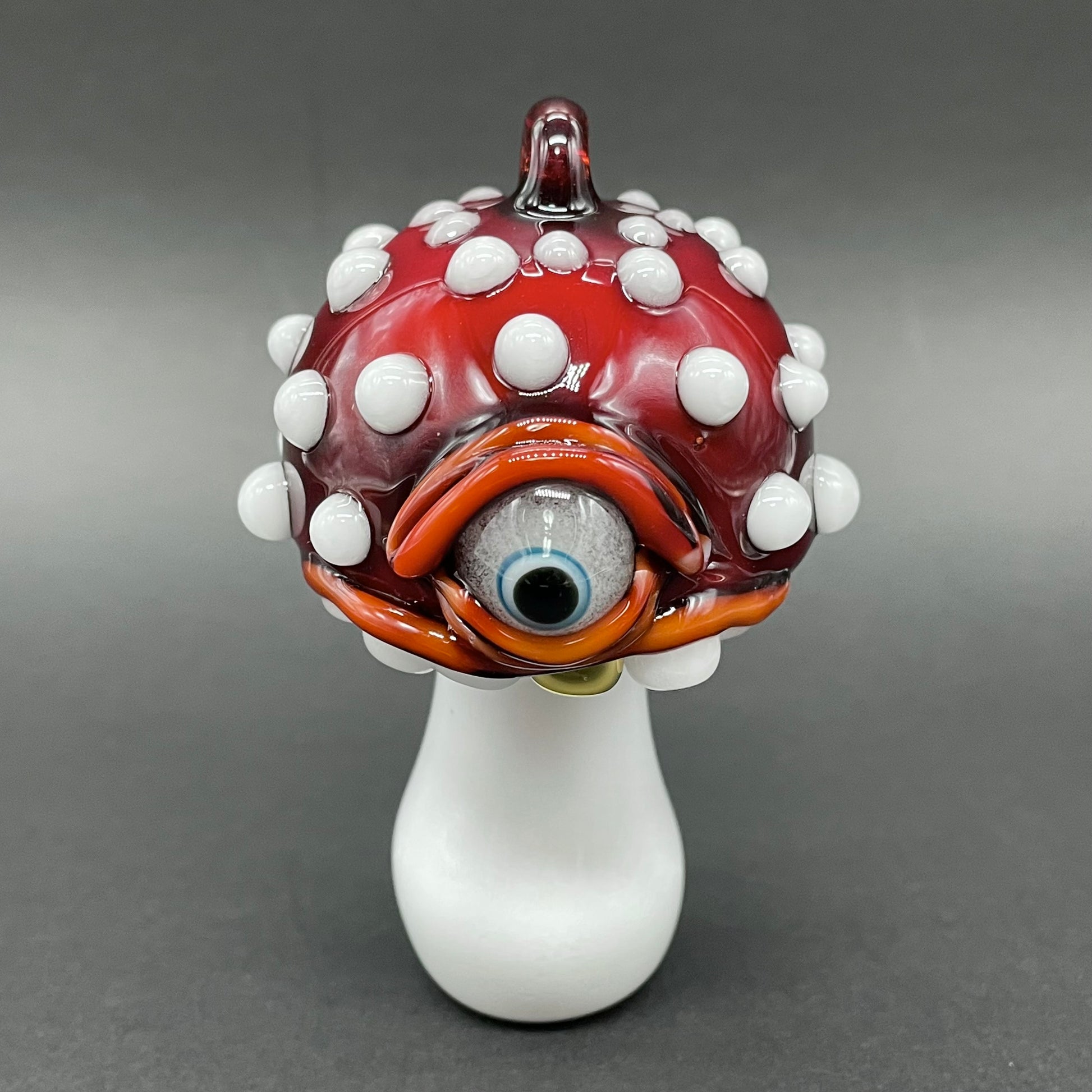Close-up of Cyclops mushroom ornament - handcrafted glass