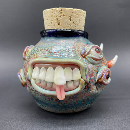 Close-up of Large bizarre glass cork jar - handcrafted glass