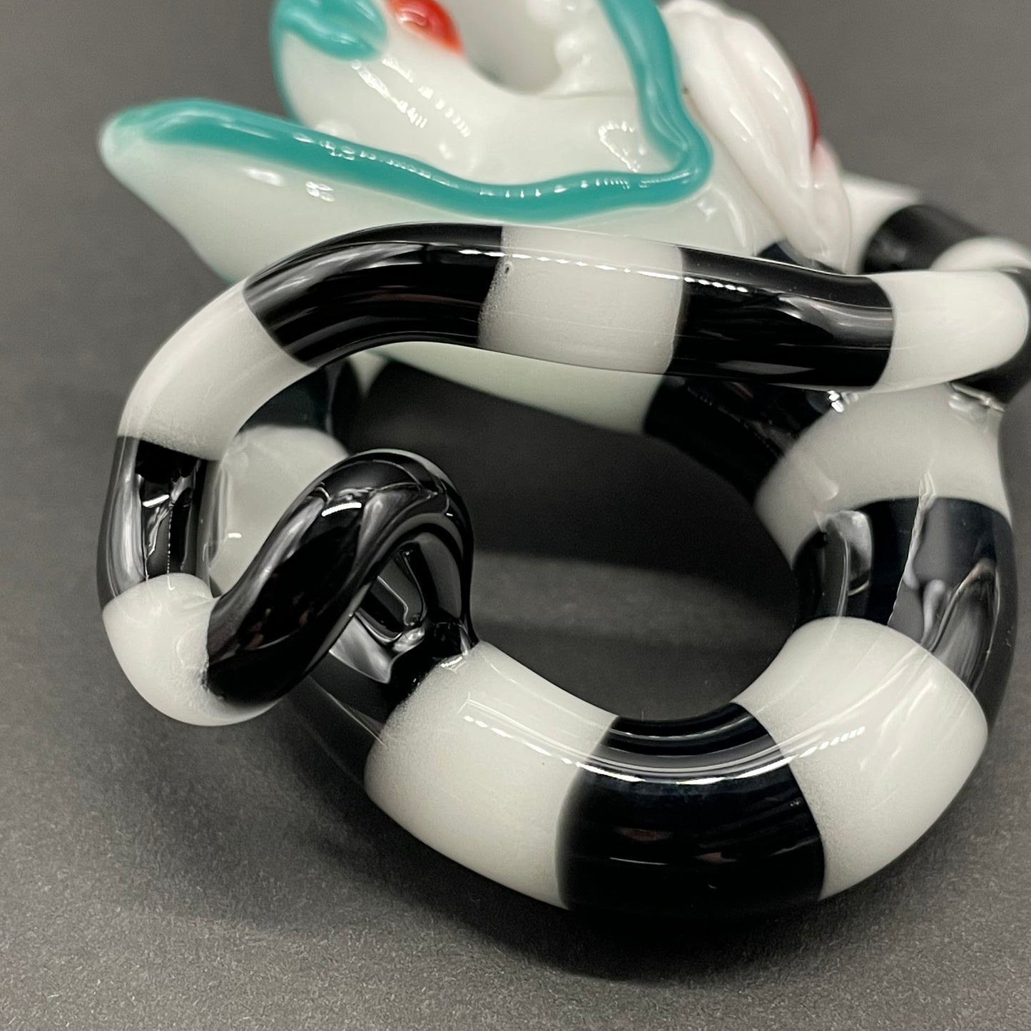 Beetlejuice Inspired handblown solid glass Sandworm sculpture - coiled black and white striped sandworm with white worm head, teal tongue, red eyes - Leviathan Glass