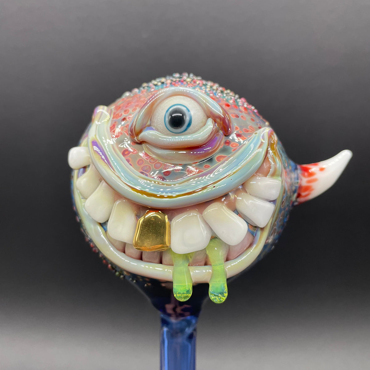 Hand Blown Glass Monster Watering Globe - round cyclops head, blue iris eye, white teeth, gold tooth, teal tongue drips, teal glass stake - Leviathan Glass