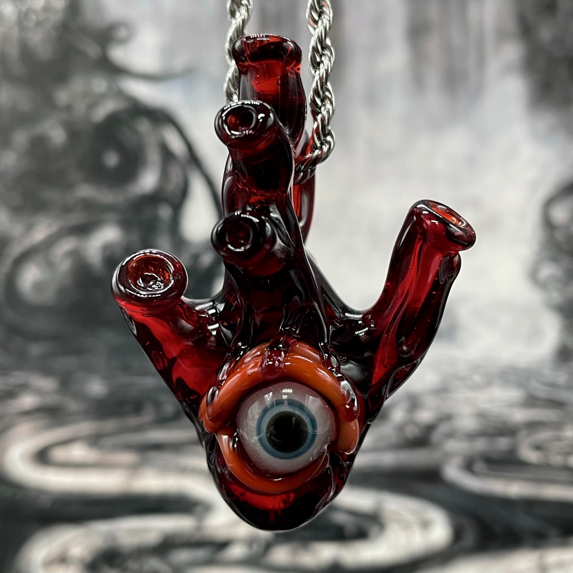 Close-up of Anatomical cyclops heart pendant - handcrafted glass