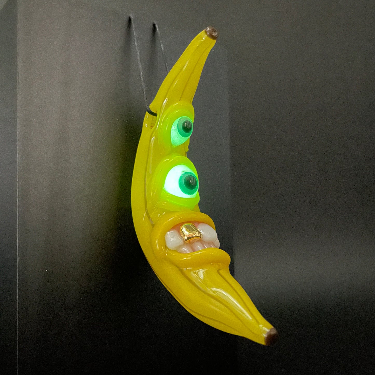 Grinning glass banana pendant