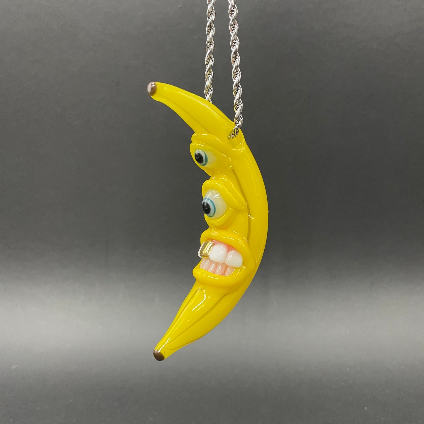 Grinning glass banana pendant
